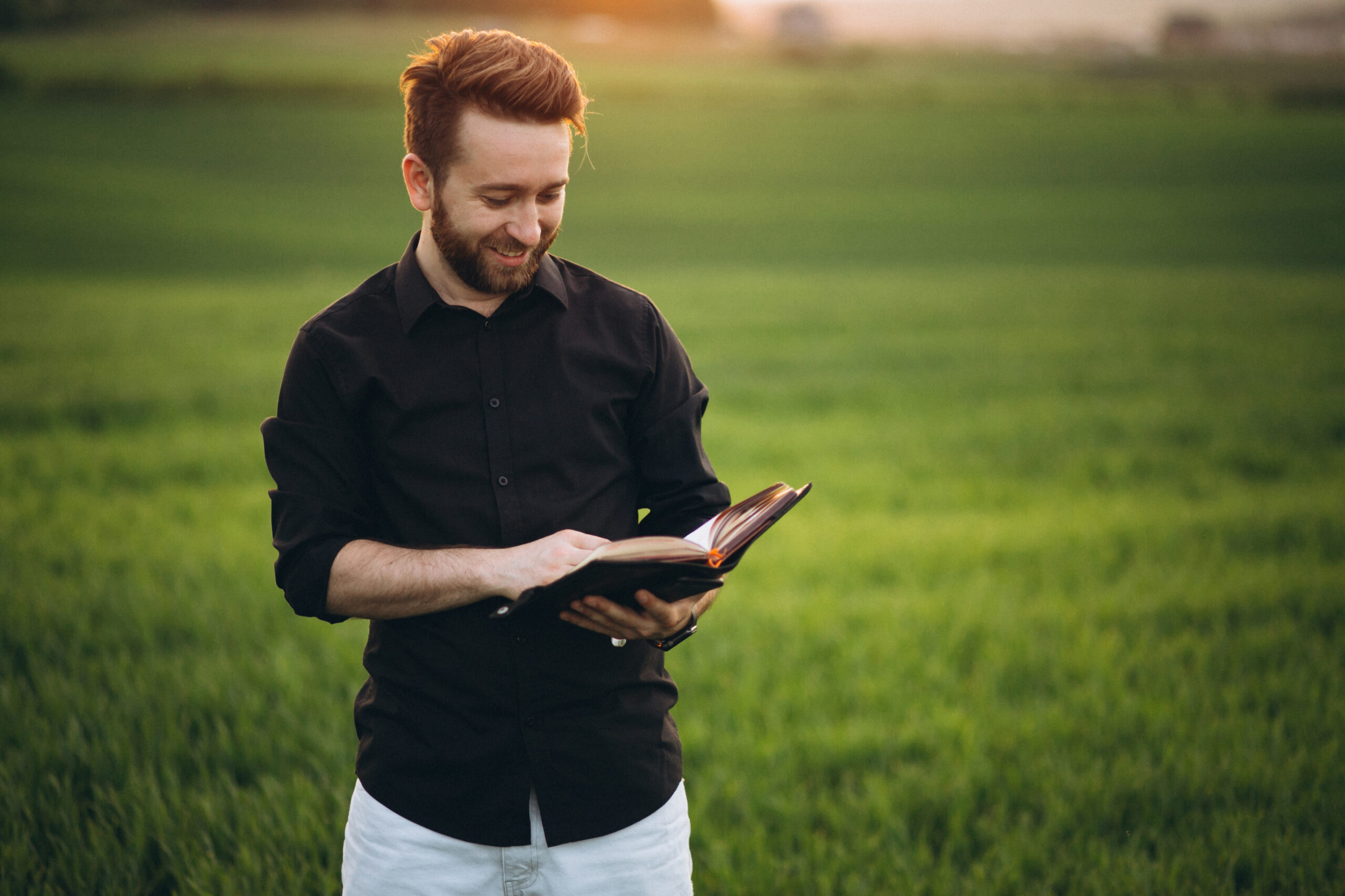 homem-negocio-lendo-um-livro-em-um-campo-scaled Como Sentir Vontade de Ler a Bíblia?